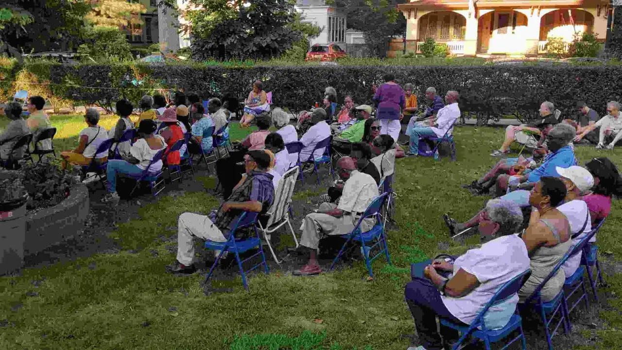 A group of people sitting in lawn chairs.