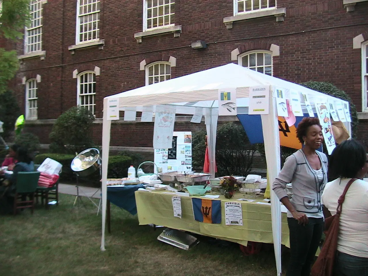 A woman standing next to an outdoor tent.