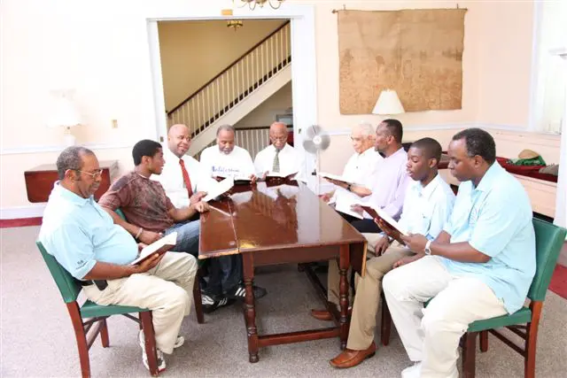 A group of men sitting around a table.