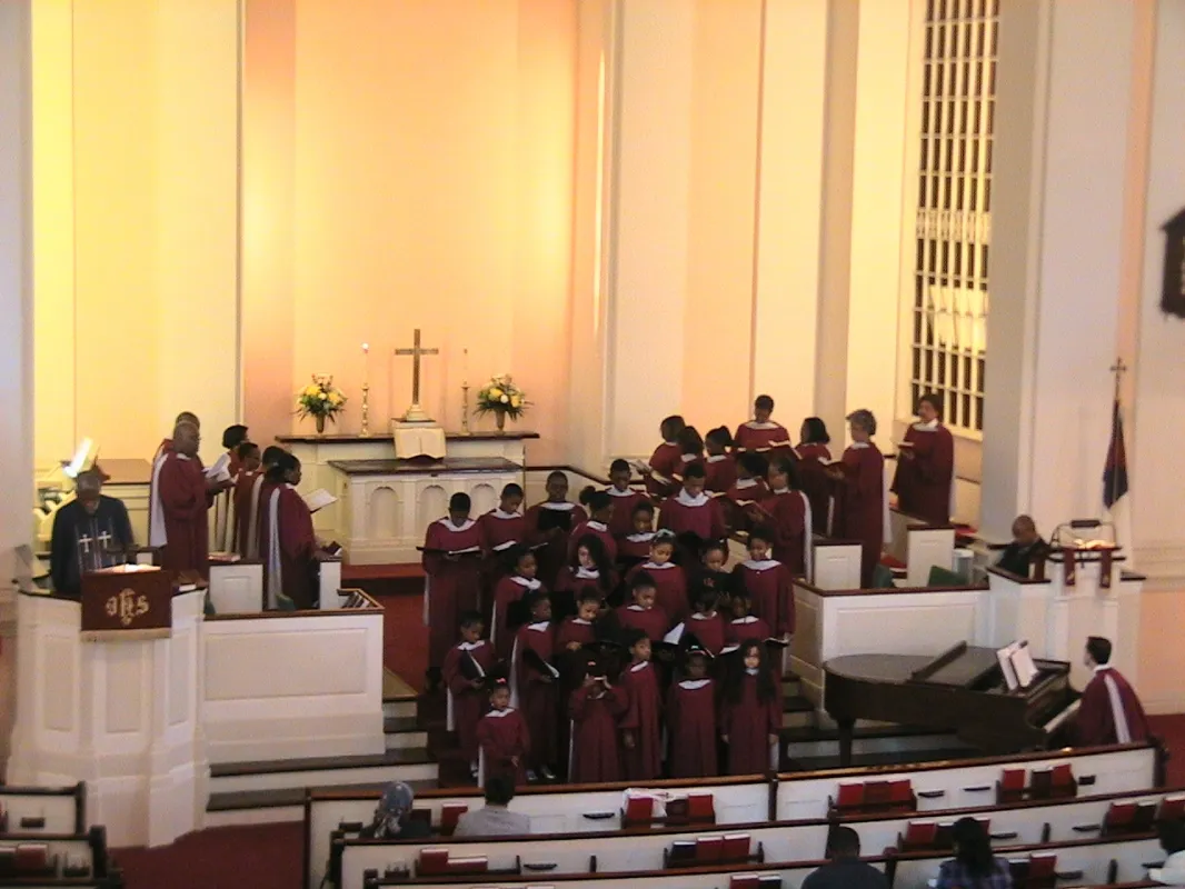 A choir is standing in front of the altar.